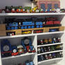 A collection of Thomas the Tank Engine merchandise displayed on a shelving unit.
